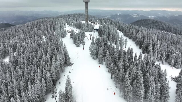4K Beautiful aerial view of winter Rhodope Mountains and Pamporovo ski resort, Smolyan Region, Bulgaria. Snow is falling during the shooting.