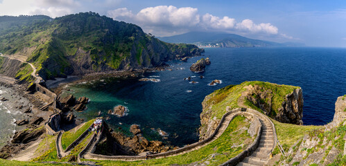 long and winding stone stairs leading up to the Church of San Juan de Gaztelugatxe with a view of...