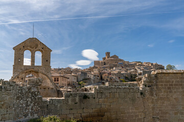 view of the picturesque historic village of Ujue in Navarra with church ruins and hilltop castle