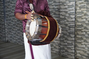 Onam celebrations. Men wearing 'mundu' perform on 'Chenda', a traditional percussion instrument. Incredible India. Single Drummer. Man playing an ethnic musical instrument. - Goa India May 2022
