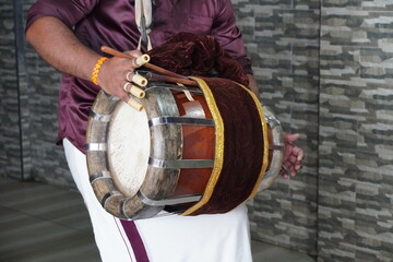 Onam celebrations. Men wearing 'mundu' perform on 'Chenda', a traditional percussion instrument....