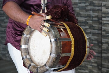 Onam celebrations. Men wearing 'mundu' perform on 'Chenda', a traditional percussion instrument....