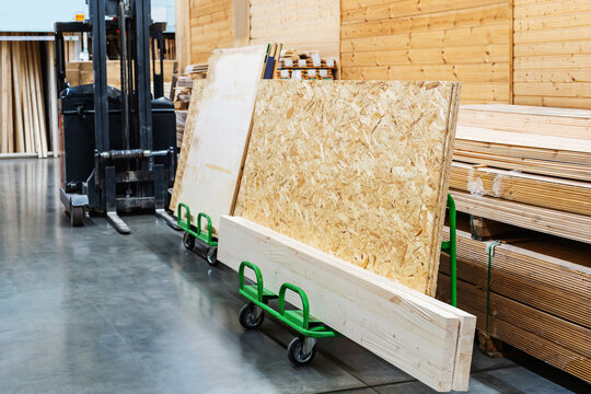 OSB sheets on a transport trolley. Trade in building materials and lumber in the trading network. Foreground