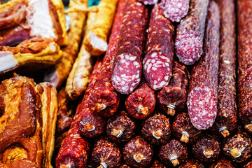 Smoked sausage on the counter in the store. Trade in meat products in a retail network. Close-up