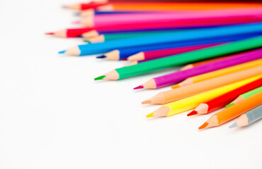 School stationery items. Creation Multicolored pencils on a blank white sheet. On a white background. Children's drawing, artist.
