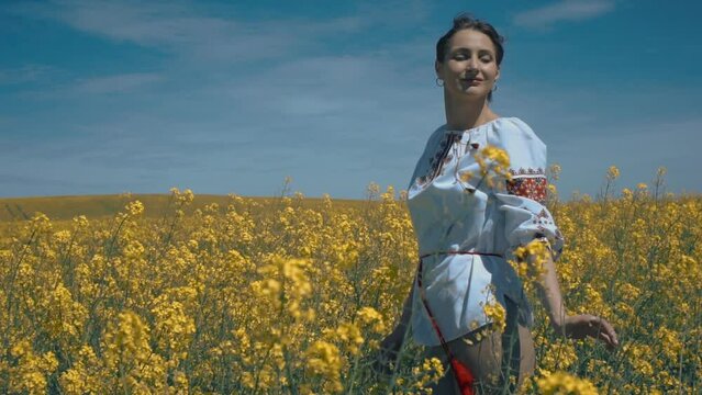 Ukrainian woman in ethnic dress in the field