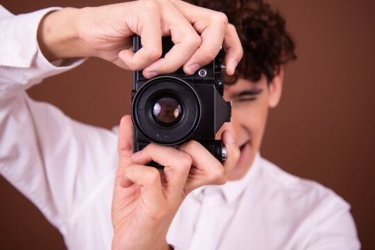 A young attractive guy is taking pictures.
