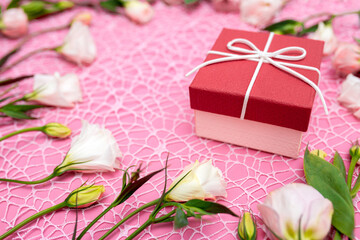 Gifts in the form of hearts on a pink background with the inscription love flower bouquet....