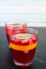 Two Glasses of Chilled Red Wine Sangria Isolated on Black Table