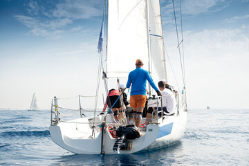 Crew on sailboat during regatta - obrazy, fototapety, plakaty