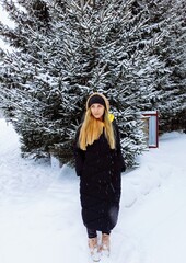 a girl in a winter landscape enjoys the beauty of winter