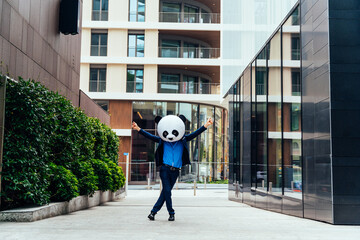 Storytelling image of a business man wearing a giant panda head