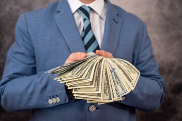 a strong, well-dressed man receives a large sum of dollars for his services.