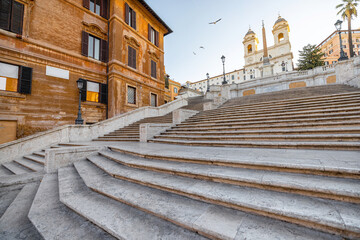 Cityscape with famous Spanish Steps and church of the Santissima at sunny morning in Rome. Visiting...