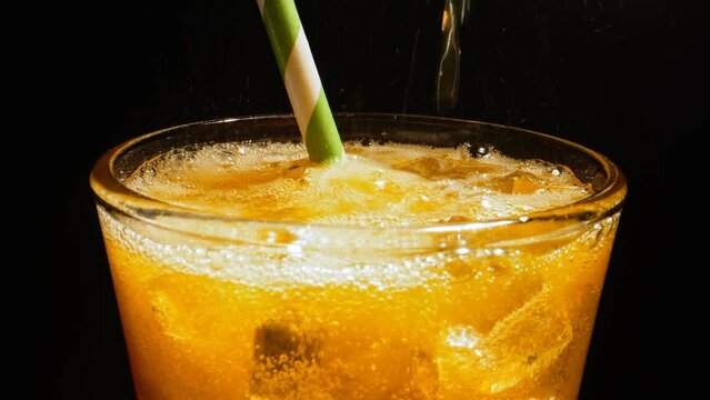 Pouring fresh orange lemonade or mocktail.