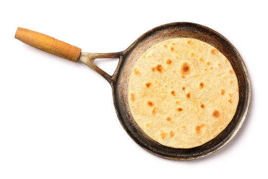 roti, also known as chapati or indian bread, a type of flat rough south asian bread on a roti pan, freshly baked indian flat bread isolated on white background