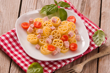 Ruote pasta with tomato and ham.
