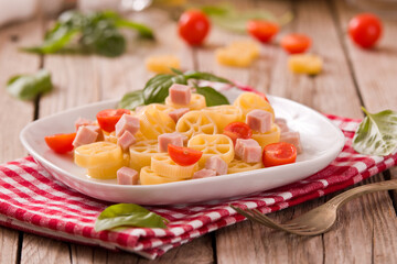 Ruote pasta with tomato and ham.