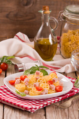 Ruote pasta with tomato and ham.