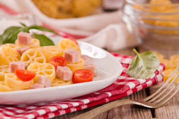 Ruote pasta with tomato and ham.