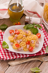 Ruote pasta with tomato and ham.