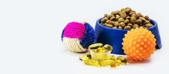 bowl or plate of dog and cat food, toys and vitamins. Omega 3 as a supplement or vitamin for pets, healthier fur, copy space