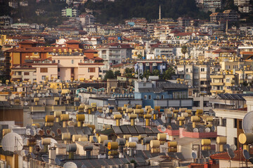 Fototapeta premium Turkey, Alanya, 30.08.2021: Water barrels and solar panels on rooftops in Turkey. Travel to Turkey.