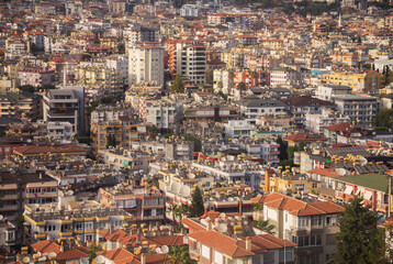 Fototapeta na wymiar Turkey, Alanya, 30.08.2021: The city of Alanya (Turkey) from a bird's eye view. Densely populated city from above. Travel to Turkey.