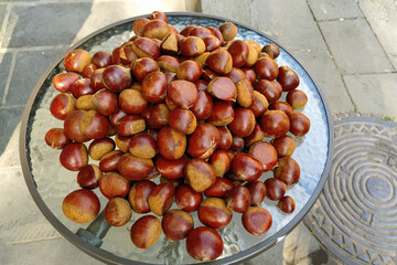 autumn chestnuts. raw chestnuts chestnuts on a glass table