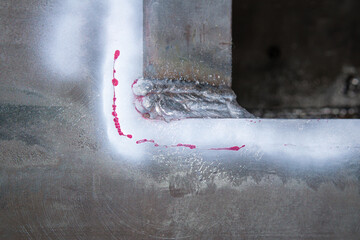 Crack on the surface of steel with Red color defect Penetrant Testing process or PT test after...