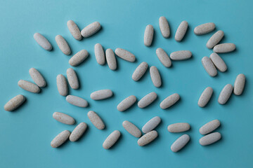 Blue medical background with pills. Drug treatment. Overdose. Dietary supplements. High quality photo