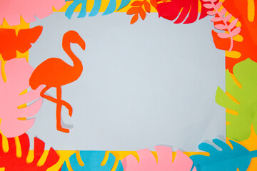 gray background for copy space surrounded by colorful jungle leaves on flamingo leaf, creative summer tropical design