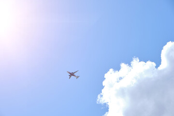 Plane takes gainst background blue sky and white clouds.