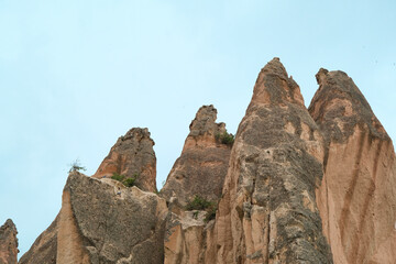 Turkish Sculpted Stones Photo with Copyspace, Unusual View Of The Sculpted Rock Hewn Mossy Stones in Cappadocia, Turkey. 