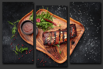 Grilled ribs with sauce on a wooden board