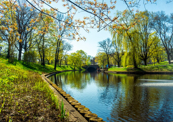 spring view on a river chanel in a green city park