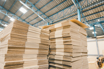 Folded cardboard corrugated paper box packaging stacking in factory