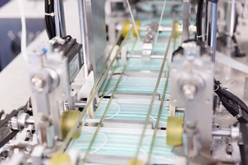 Face mask in automatic production line at manufacturing factory