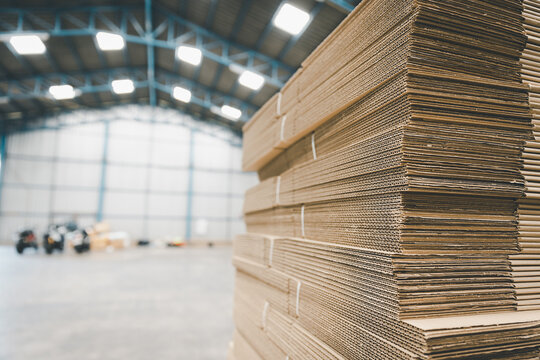 Folded cardboard corrugated paper box packaging stacking in factory