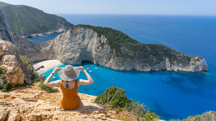 Girl posing with a view to Navagio (Shipwreck) beach in Zakynthos Greek island