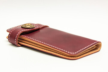 Women's long leather wallet in Maroon leather color isolated on a white background.