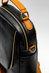 Naklejka premium Classic black leather bag with white background isolation.