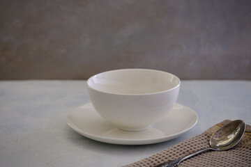 White ceramic plate with a bowl on a concrete table
