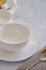 White ceramic plate with a bowl on a concrete table