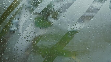 Man easily erases drawn heart from window with palm. Man wipes off mist from window glass. Person destroys drawing on misty window closeup