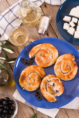 Pastry swirls with cheese and olive filling.