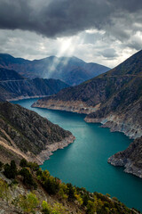 Ray of light leaking through the clouds, dam lake. Deriner-Artvin