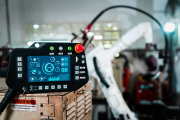 Robotic arm and its controller adept panel in a factory workshop . Industry robot programming software for automated manufacturing . - obrazy, fototapety, plakaty