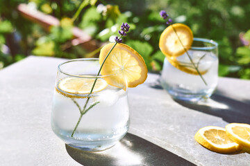 Cool lavender homemade lemonade with lemon slices and lavender flower. Healthy organic summer soda...