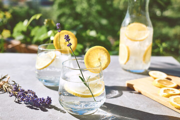 Cool lavender homemade lemonade with lemon slices and lavender flower. Healthy organic summer soda drink. Detox water. Diet unalcolic coctail.